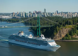 A cruise ship sails beneath the Lions Gate Bridge