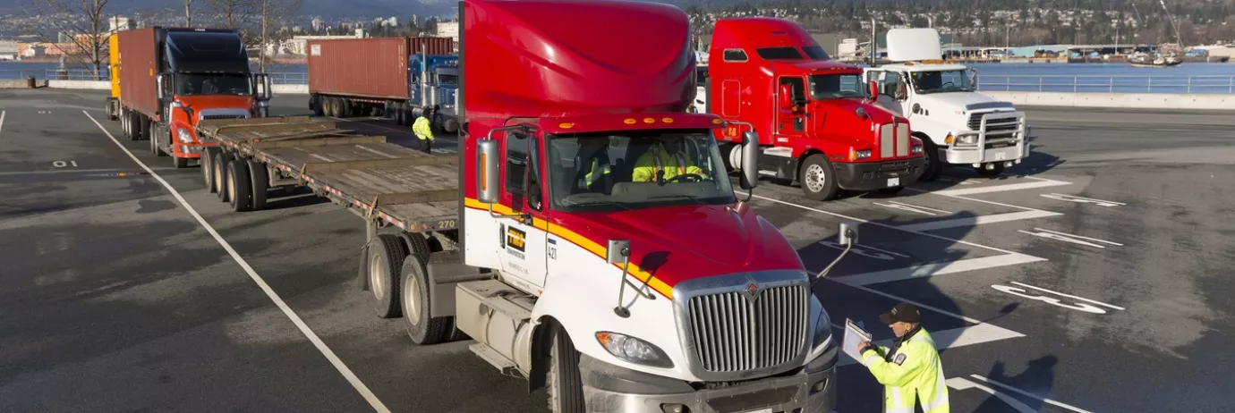 Two line-ups of parked container trucks